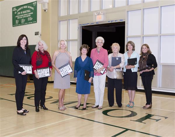 A group of women holding papers